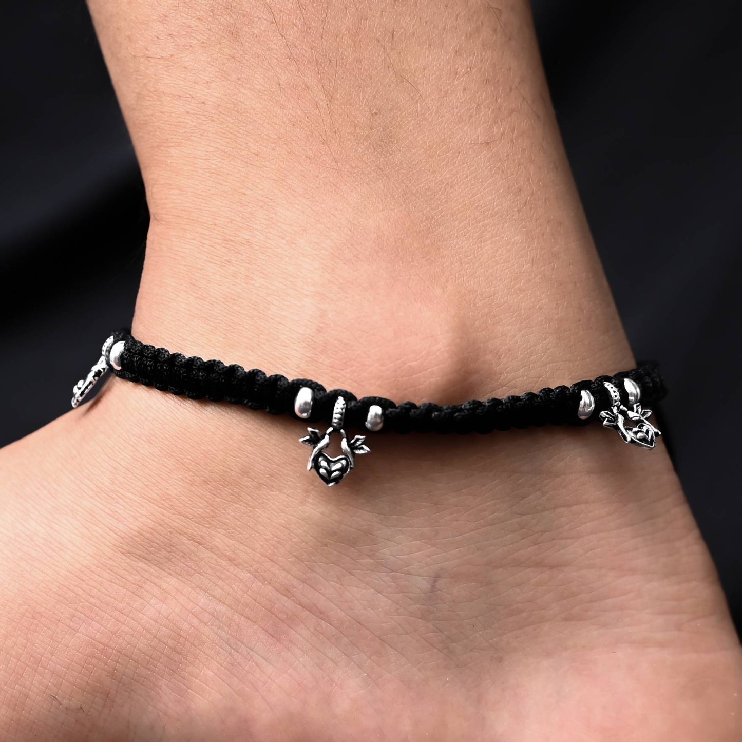 Elegant 'Pigeons' Love' anklets in oxidized silver and black thread.