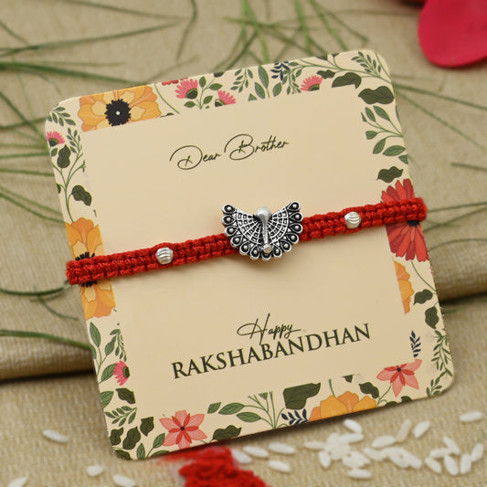 Silver Rakhi with an open feather peacock design, perfect for boys.