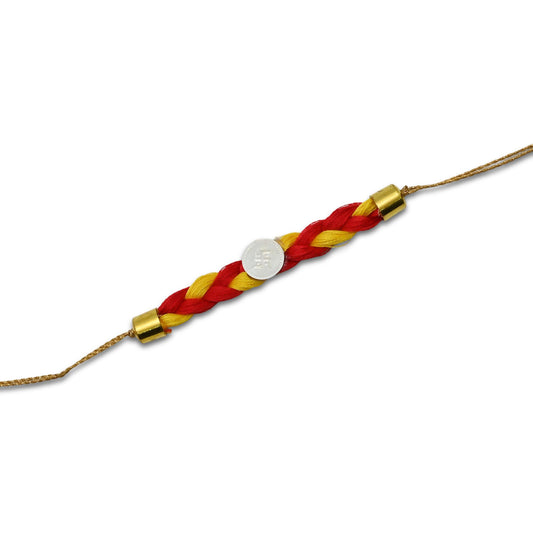 Boys' Rakhi featuring a silver Swashtika centerpiece with red and yellow tangle Moli