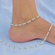 Elegant silver anklet adorned with green and silver beads.