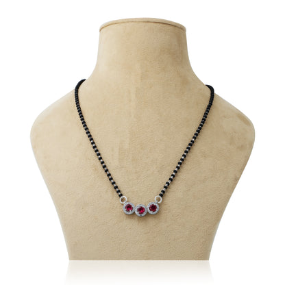 Elegant mangalsutra featuring black beads and striking purple round gemstones