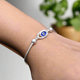 Elegant silver bracelet with a central blue evil eye charm