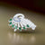 Elegant silver saree pin featuring a peacock design adorned with green and blue stones