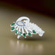 Elegant silver saree pin featuring a peacock design adorned with green and blue stones