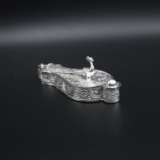Traditional silver Sindoor box adorned with a beautiful peacock pattern