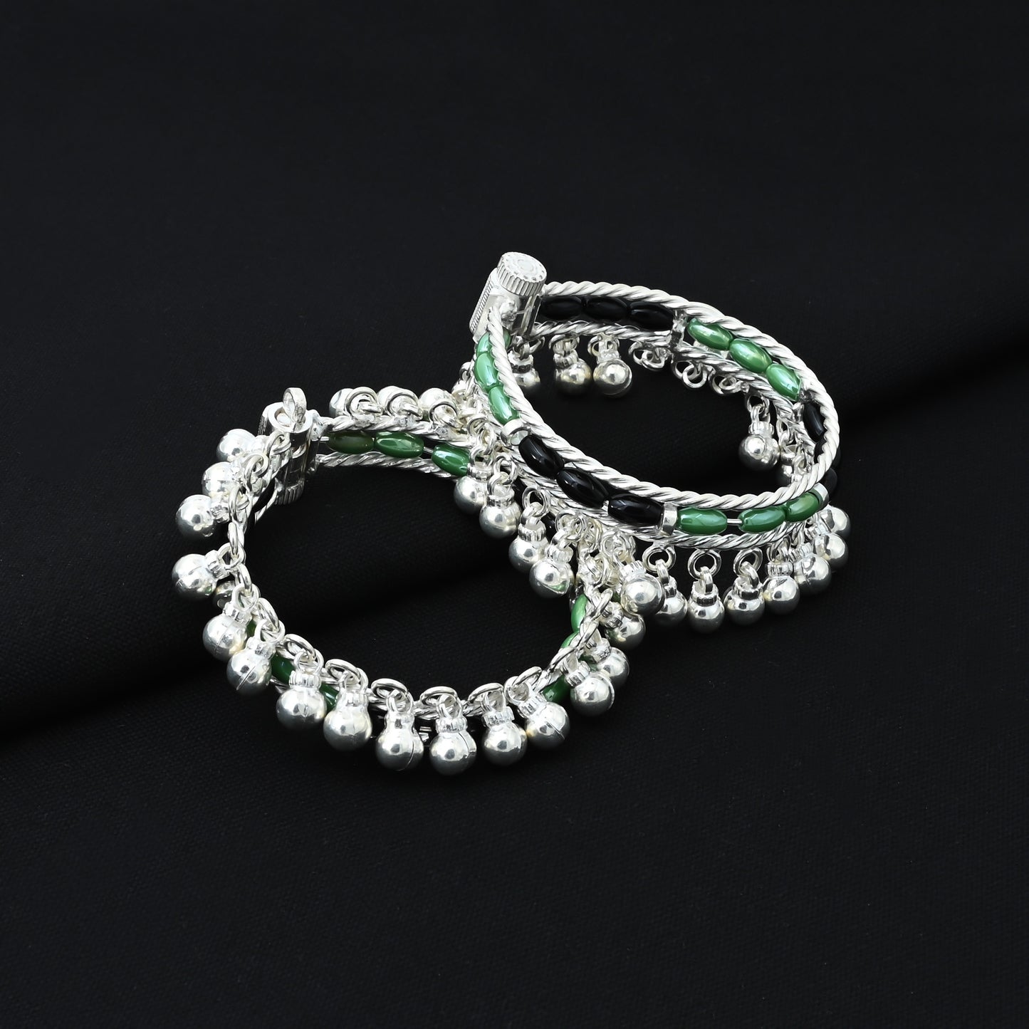 Cute baby silver kada payal featuring green and black beads with playful ghungroo details.