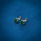 Trendy silver earrings with a striking green gemstone centerpiece