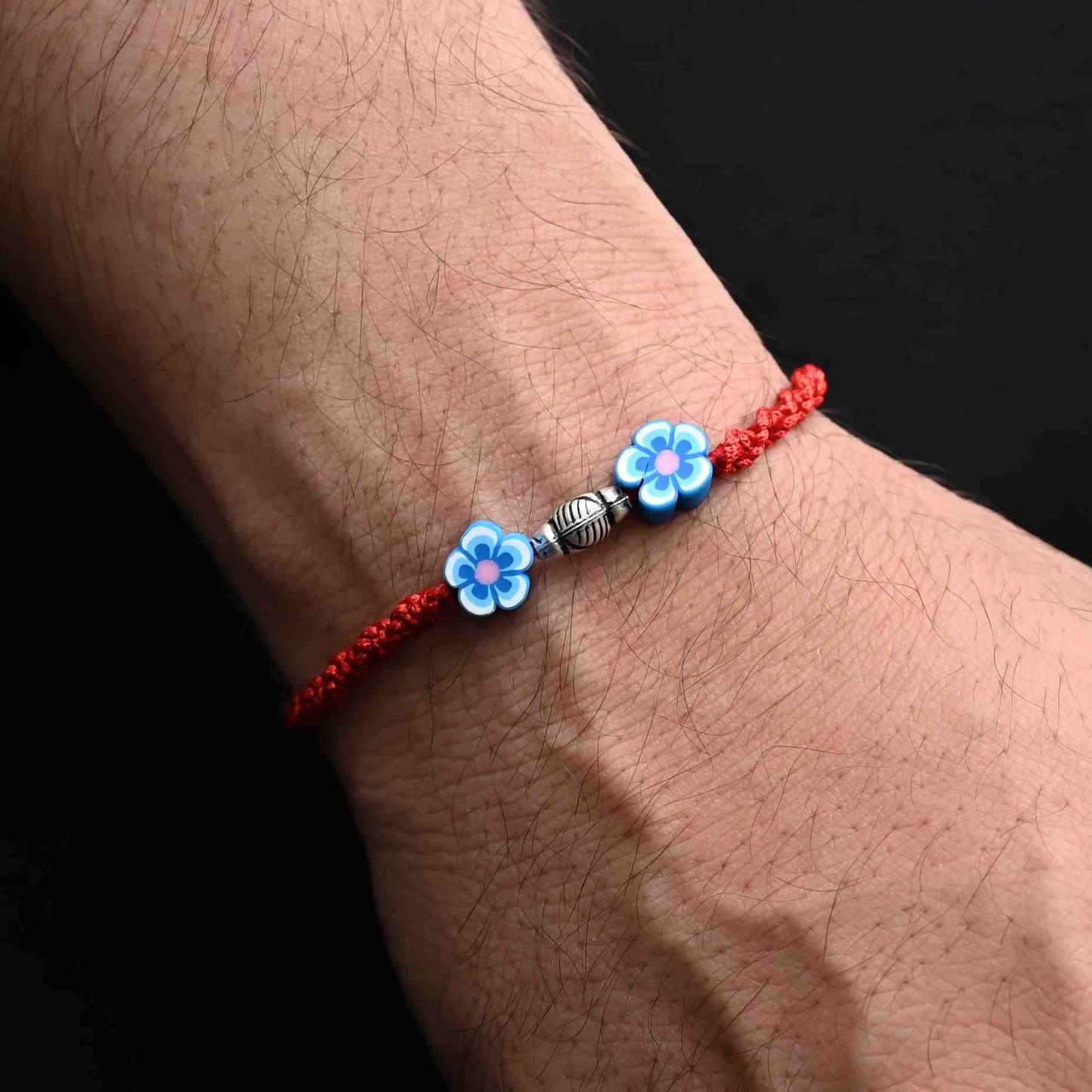 Boys' Rakhi with a beautiful blue flower motif in sterling silver