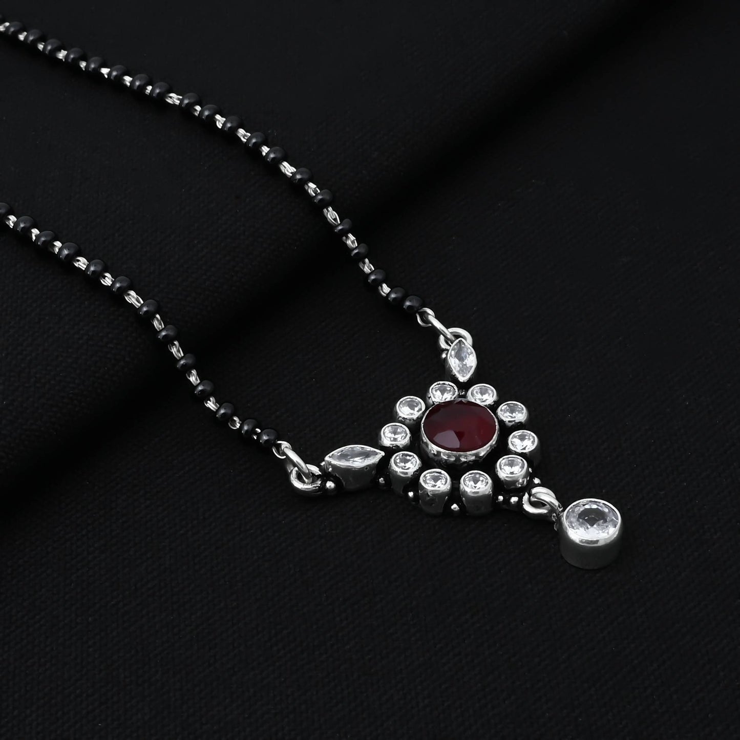 Chic sterling silver mangalsutra adorned with a vibrant round maroon gemstone