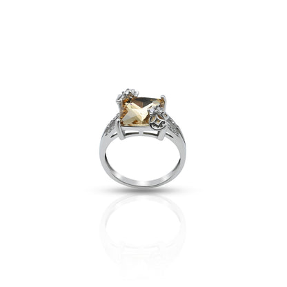 Elegant silver ring featuring center yellow gem.