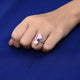 Trendy silver ring adorned with pink square stones.