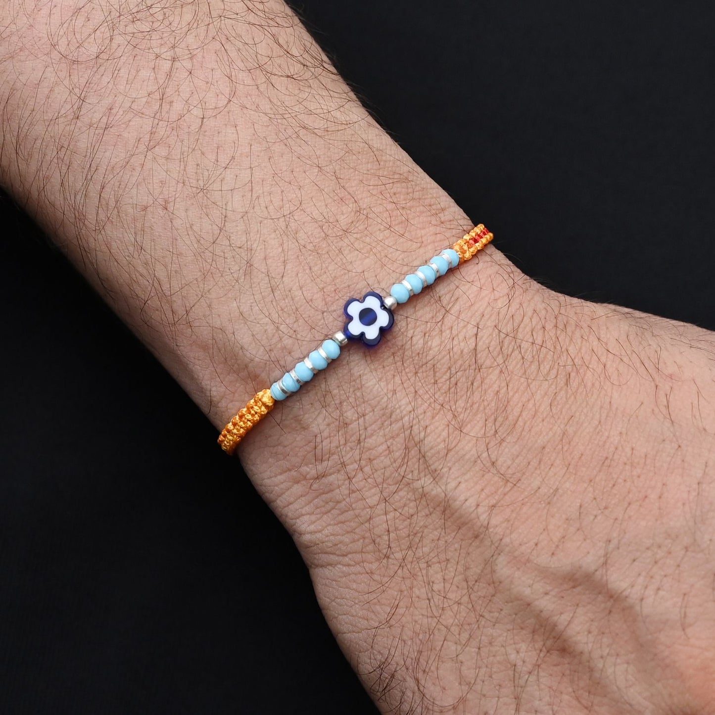 Elegant blue flower design with silver and light blue beads, ideal Rakhi for boys