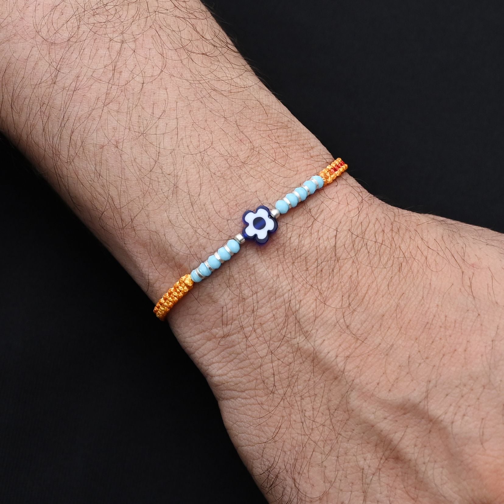 Elegant blue flower design with silver and light blue beads, ideal Rakhi for boys