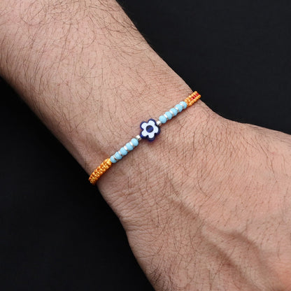 Elegant blue flower design with silver and light blue beads, ideal Rakhi for boys