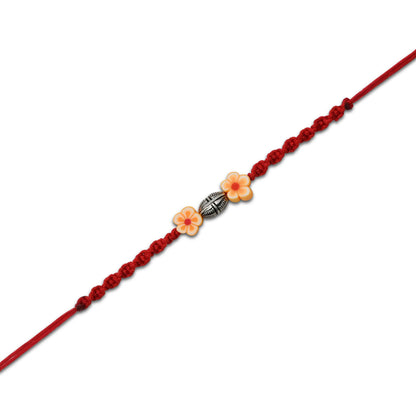 Boys' Rakhi with a sterling silver orange flower motif for a bright, colorful touch.