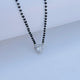 Black beads mangalsutra featuring heart-shaped stone pendant.