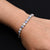 Sterling silver bracelet featuring a protective evil eye and flower design