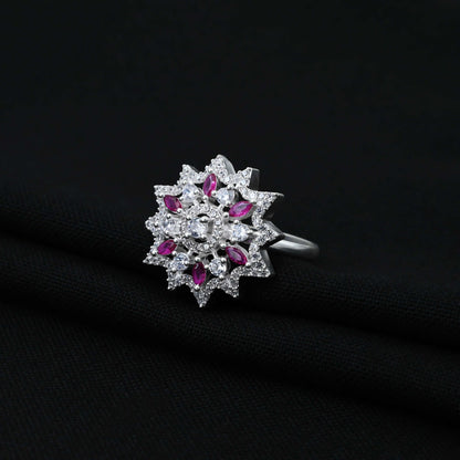 Cute silver ring with a pink gemstone at the center of a flower design for girls.