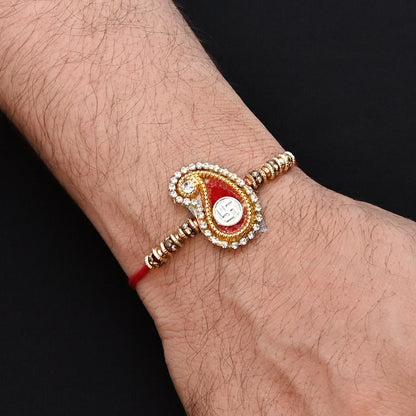 Elegant Rakhi with a silver Swasthik symbol, red theme, and a mix of colorful beads, ideal for boys.