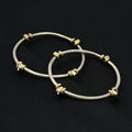 Charming silver kada with gold highlights and four diamond-shaped accents