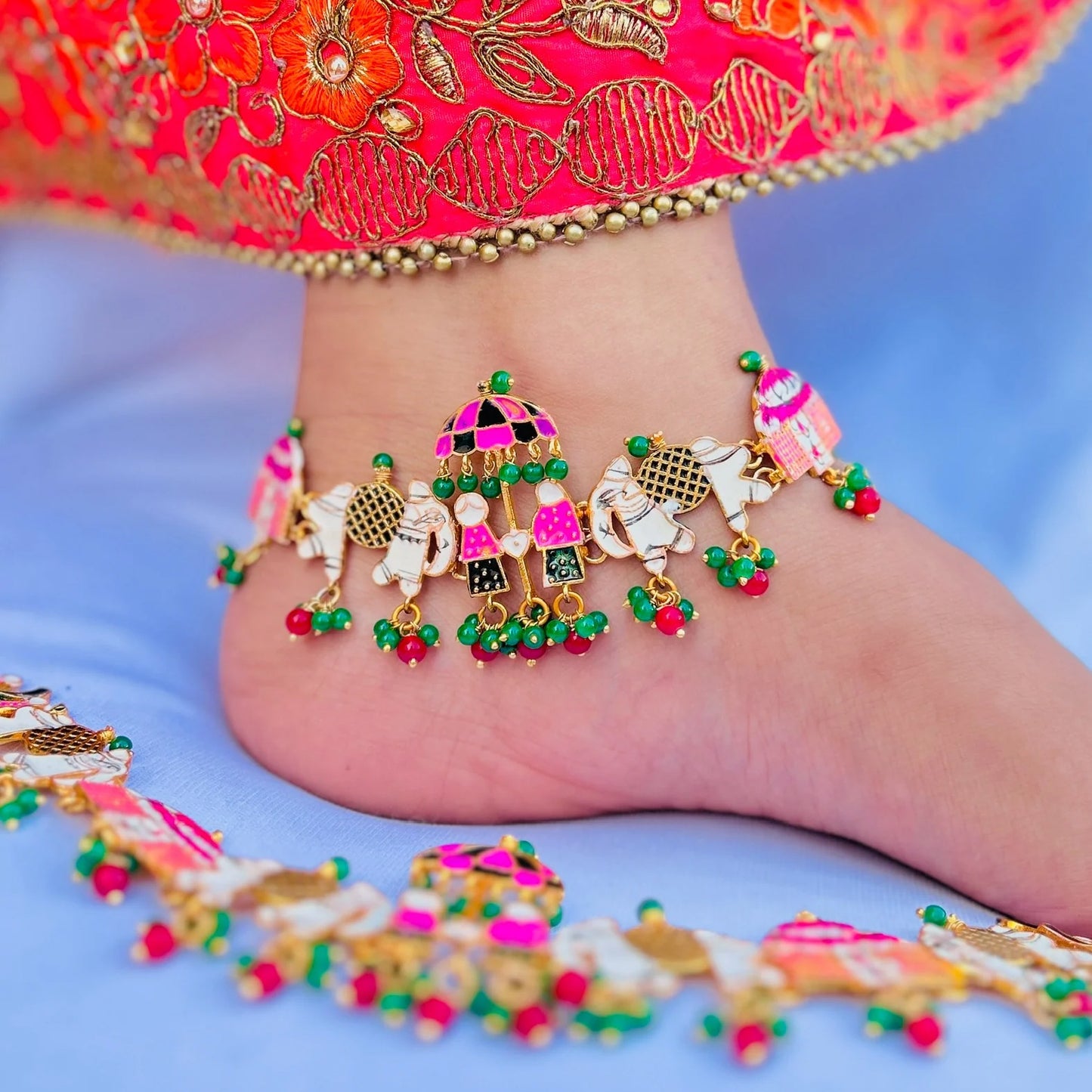 Colorful silver payal with umbrella and elephant charms.