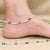 Delicate silver anklets with intricate designs and soft hues.