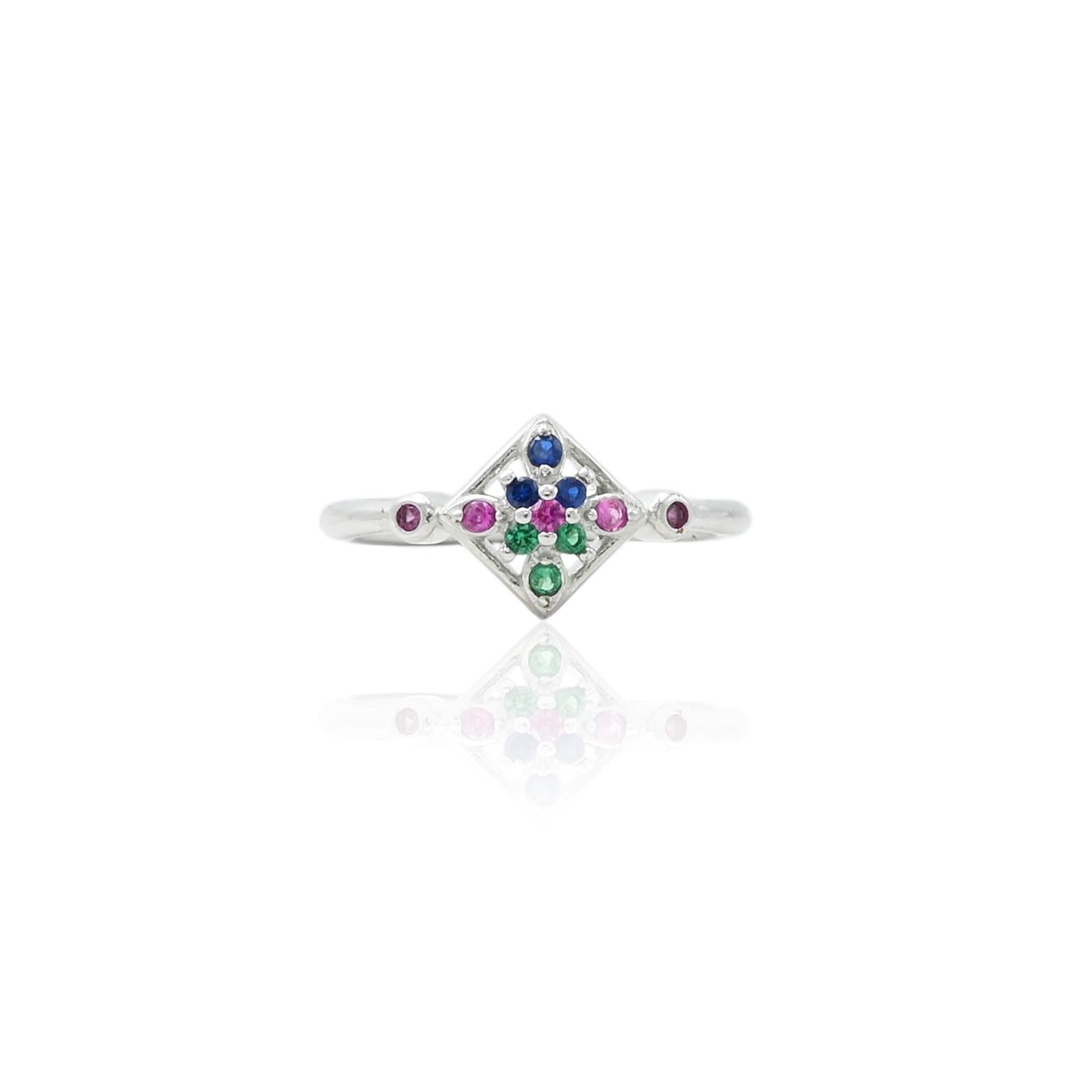 Silver ring adorned with a combination of green and pink gemstones, offering a vibrant and stylish accessory.