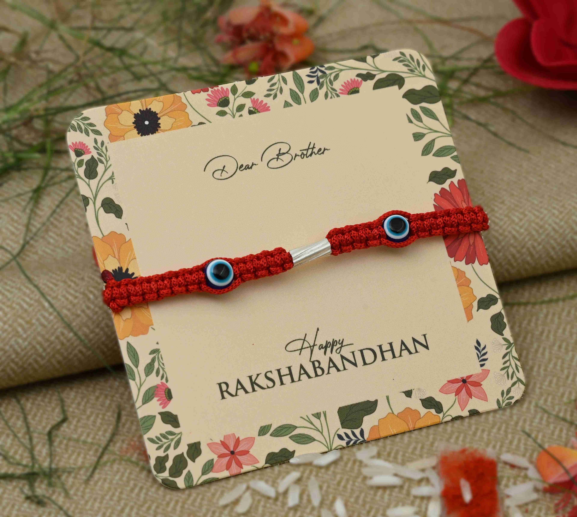 Silver Rakhi featuring two purple evil eye charms, perfect for boys.