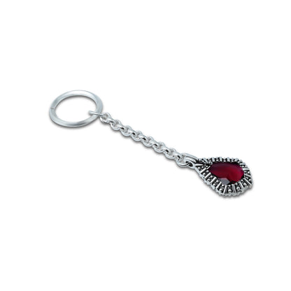 Stylish silver keychain with a striking red gemstone, perfect for a bold statement