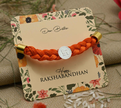 Silver center Swastika design with orange tangle Moli, perfect Rakhi for boys.