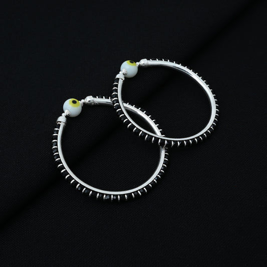 Stylish sterling silver baby kada adorned with black beads and a white evil eye accent