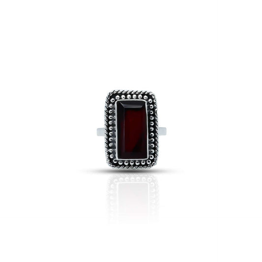 Vintage sterling silver ring with rectangular red gemstone.