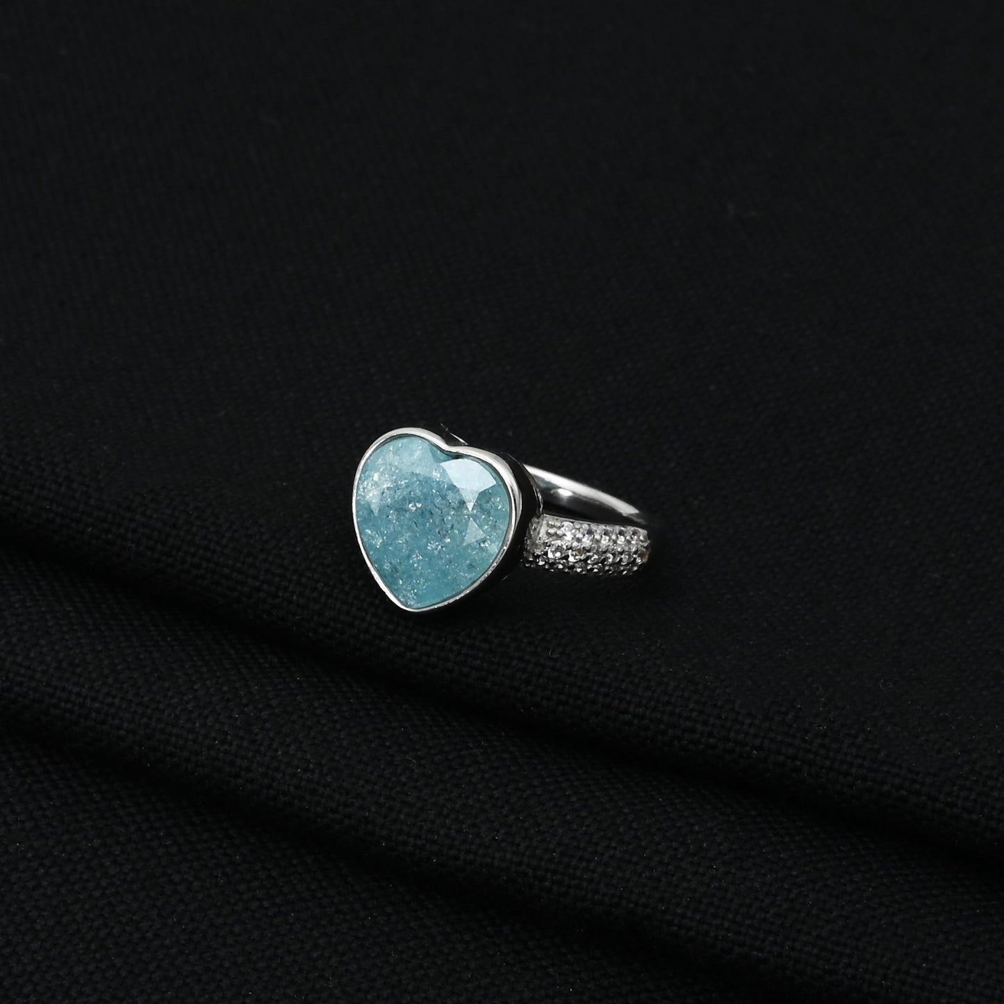 Stylish silver ring showcasing a heart-shaped sky blue gem for a soft and radiant design.