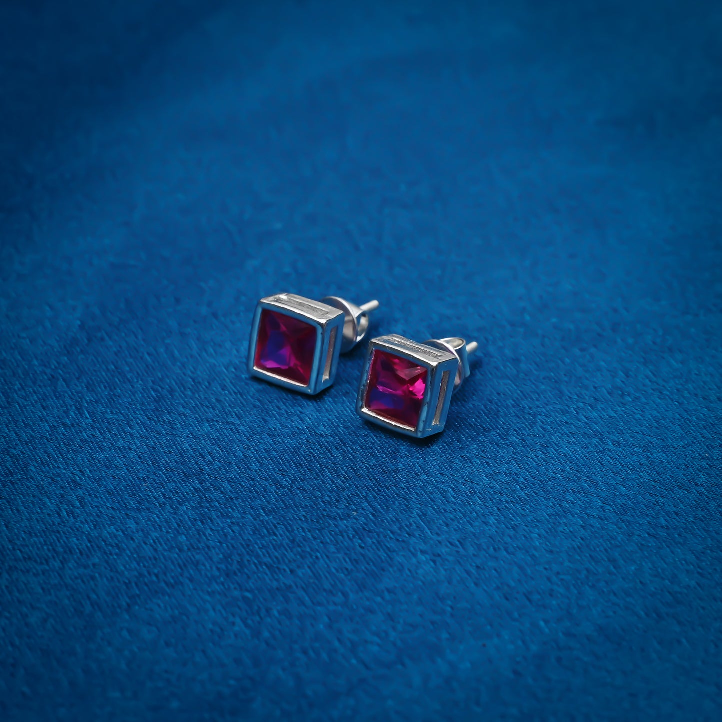 Simple silver stud earrings with square pink gemstones