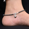 Sophisticated silver payal with a blue evil eye, complemented by black and silver beads for a bold and meaningful design