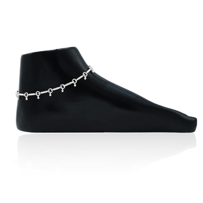 Elegant silver anklet with mini bell charms, designed to add a subtle, rhythmic touch to any outfit