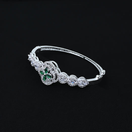 Stylish silver girls' kada adorned with a green four-leaf clover at the center