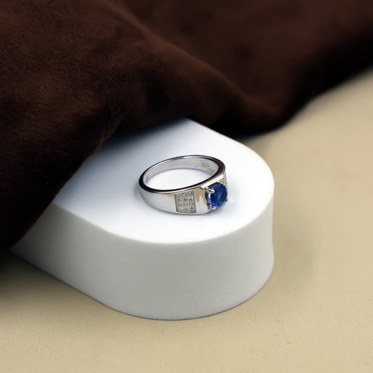 Delicate silver ring featuring a small blue stone