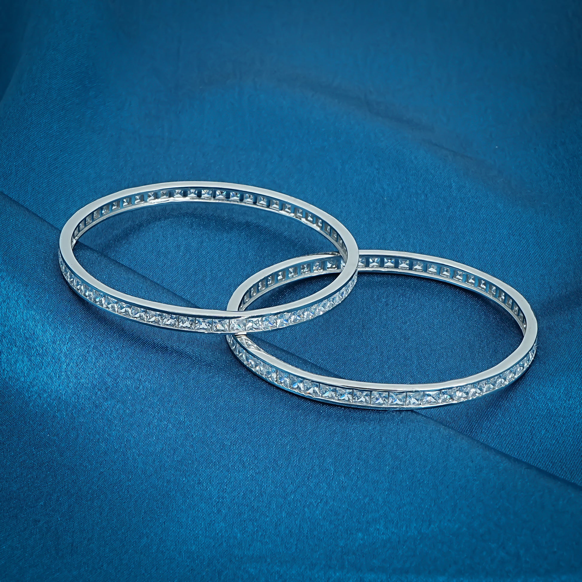 Stylish sterling silver bangles adorned with cubic zirconia stones, designed to add luxury and elegance to your look.