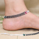 Elegant silver anklet with contrasting black and silver beads.