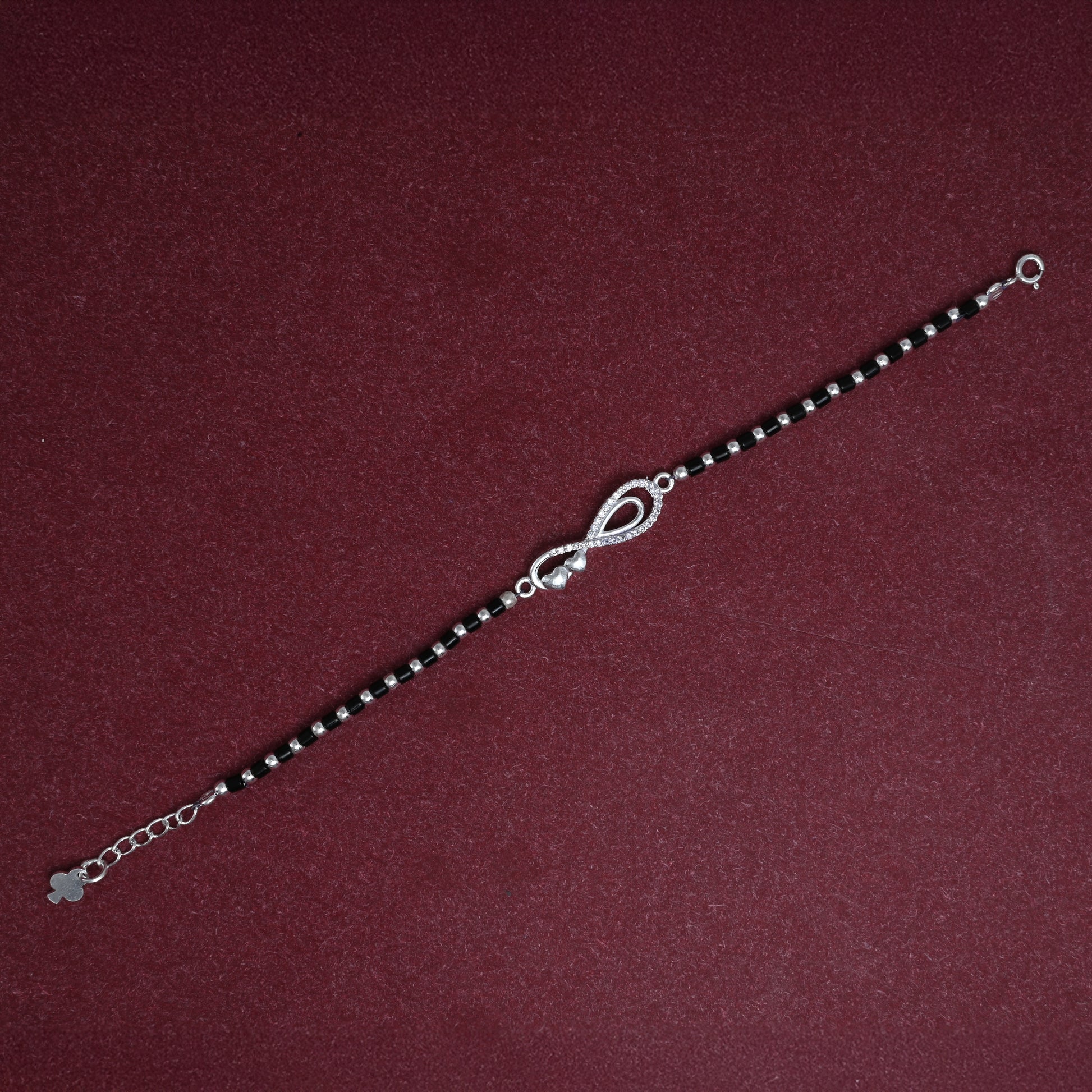 Chic black beaded silver bracelet with a classic infinity design for a stylish look