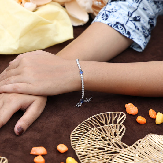 Delicate silver tennis bracelet with a striking blue stone