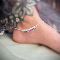 Simple silver anklet for girls with multi-color gems and silver balls.