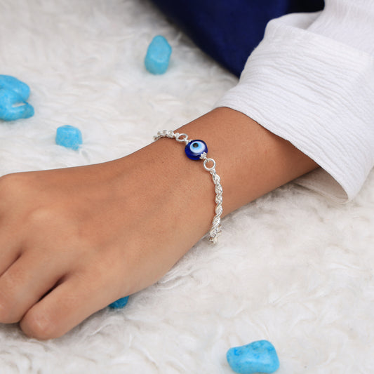 Sleek silver chain bracelet with an elegant evil eye charm