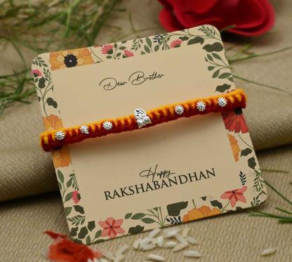 Silver center Trishul design with flower pattern beads, perfect Rakhi for boys