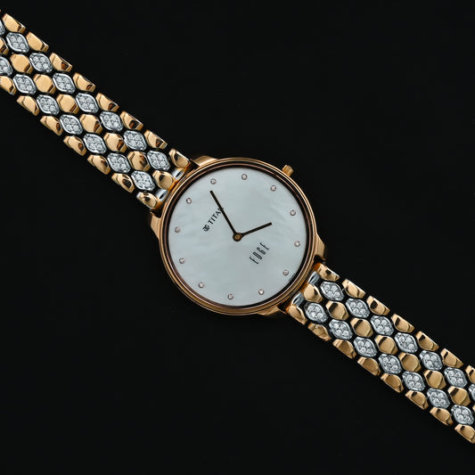 Elegant gold-plated Titan watch with white stone accents.