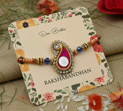 Silver center Ganesh Ji design with a pink theme and colorful beads, perfect Rakhi for boys.