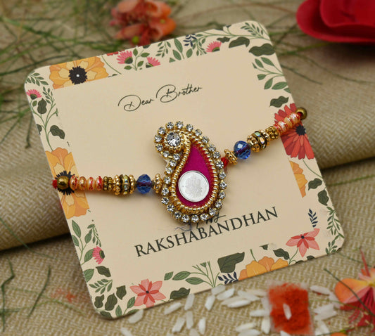 Silver center Ganesh Ji design with a pink theme and colorful beads, perfect Rakhi for boys.