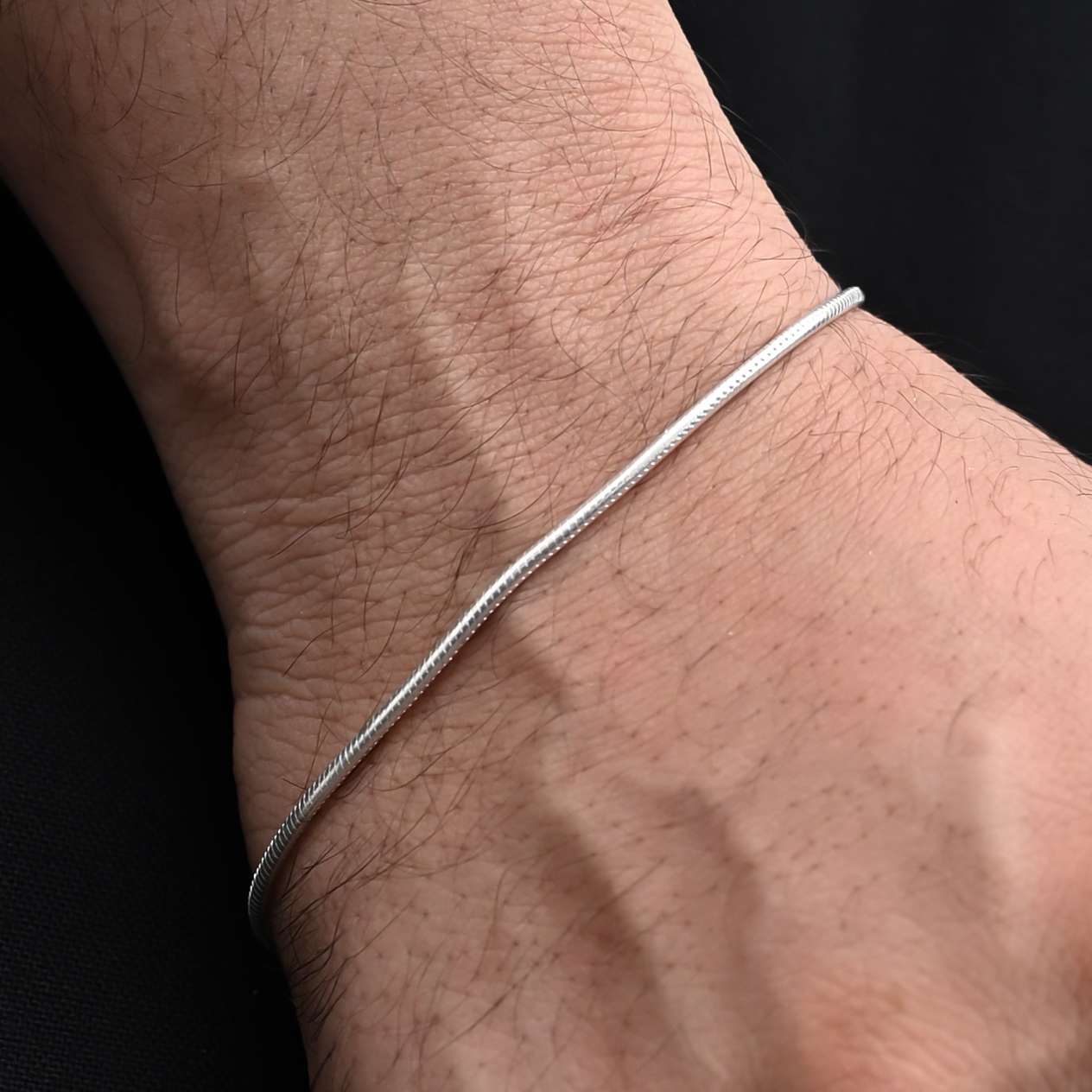 Stylish sterling silver bracelet with a clean, plain snack design for boys