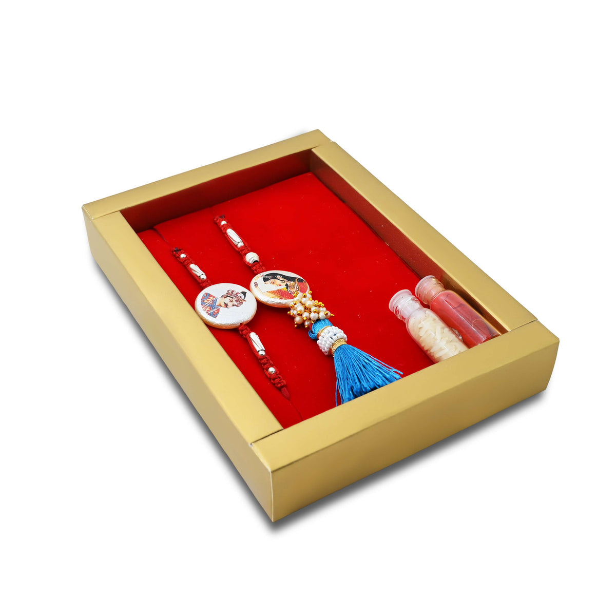 Silver Raja Rani Rakhi with a blue theme, complemented by kumkum and rice, perfect for boys.